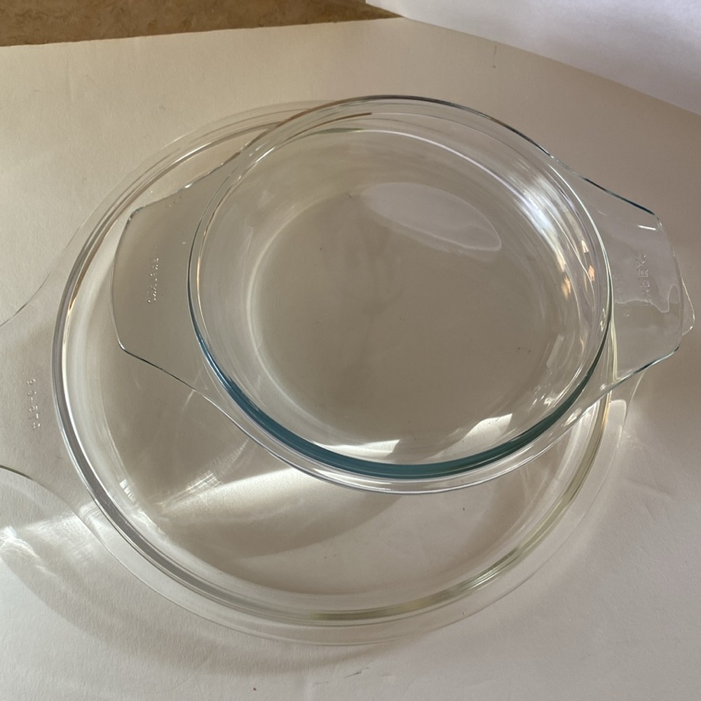 Two different Pyrex clear glass lids.